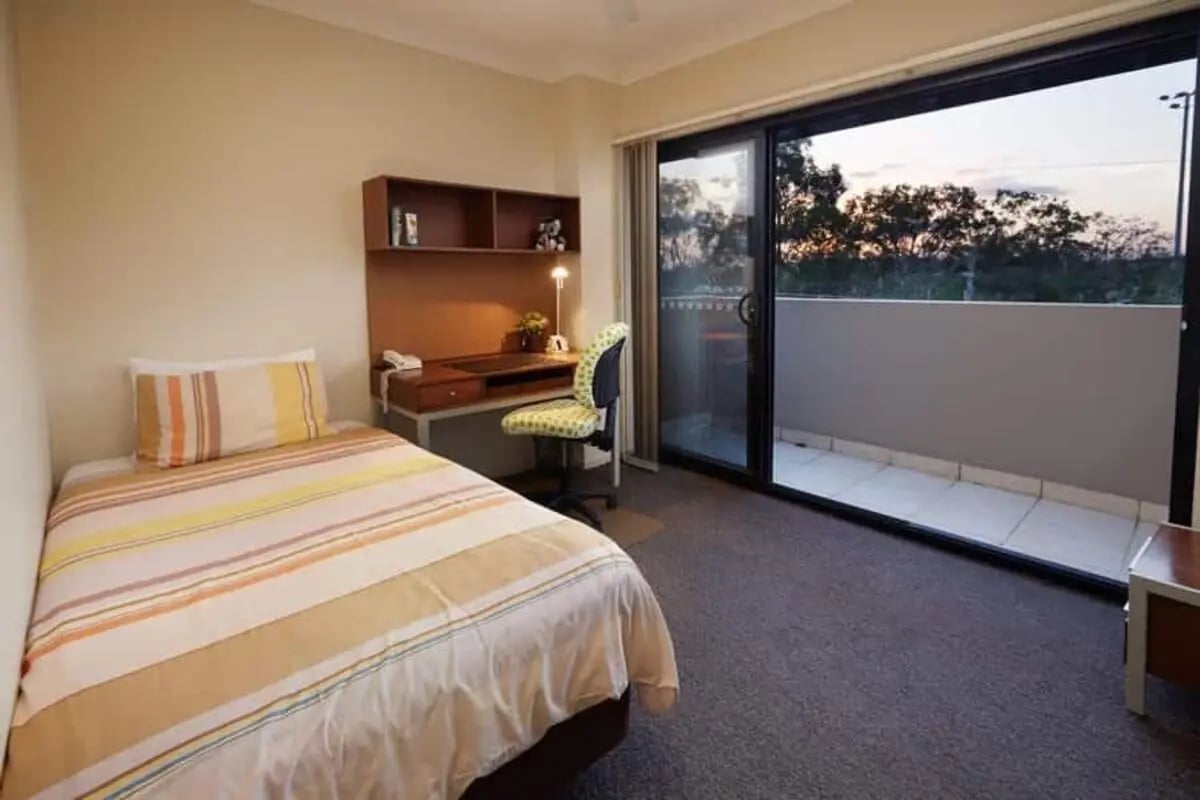 Bed desk chair and sliding door view bedroom at Genesis 1 in Brisbane Student Accommodation