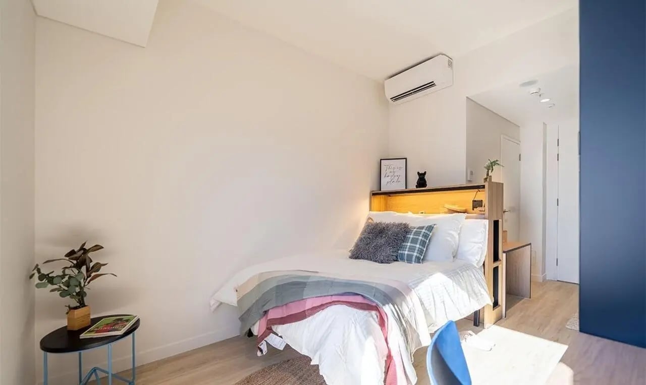 Bed side table plant air conditioner bedroom at The Switch Kensington in Sydney Student Accommodation