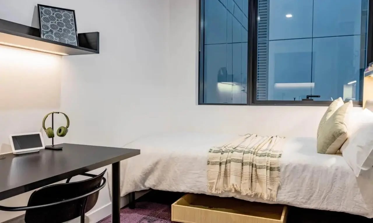 Desk bed artwork shelf headphones tablet bedroom at The Switch Melbourne Victoria Market in Melbourne Student Accommodation