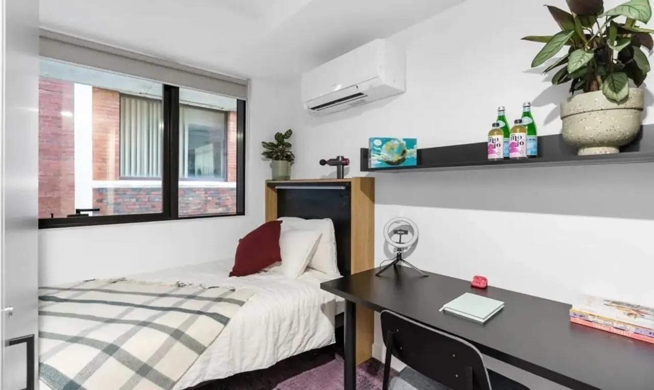 Bed desk air conditioner and window bedroom at The Switch Melbourne Victoria Market in Melbourne Student Accommodation