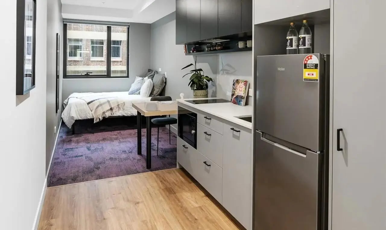 Bed fridge microwave table and counter studio apartment at The Switch Melbourne Victoria Market in Melbourne Student Accommodation