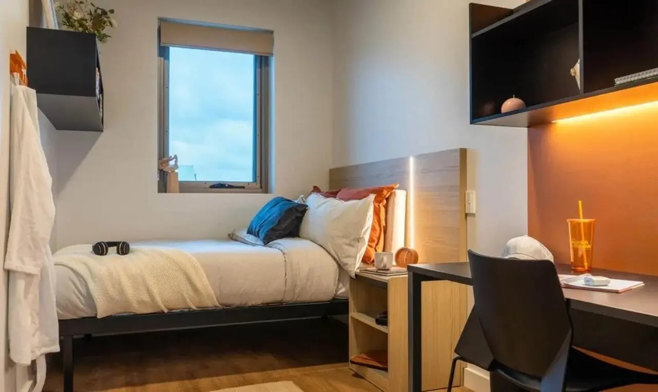 Bed desk and shelving student bedroom at The Switch Adelaide in Adelaide Student Accommodation
