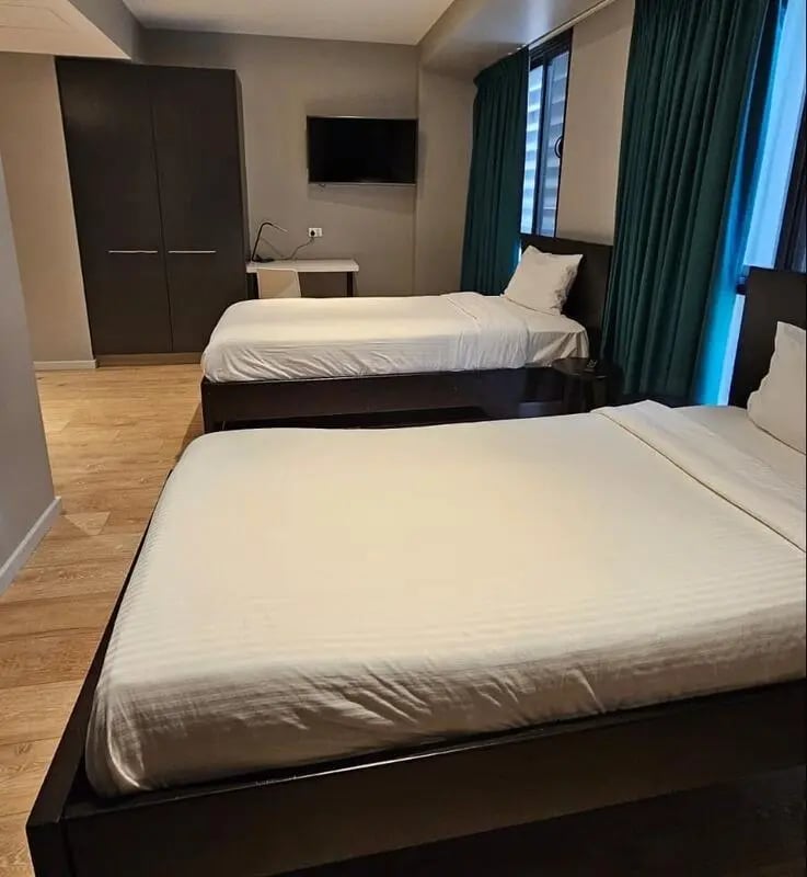 Two beds wardrobe desk television bedroom at Sydney Student Living Top Ryde in Sydney Student Accommodation