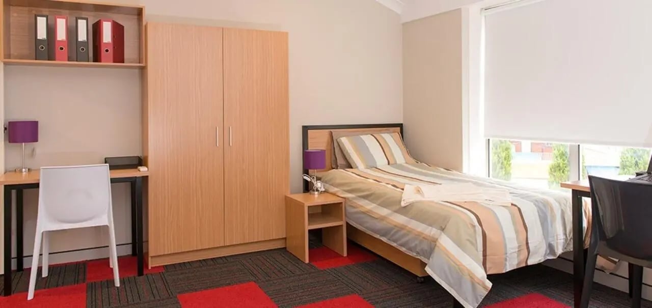 Bed wardrobe desk chair binders bedside table bedroom at Sydney Student Living Concord in Sydney Student Accommodation