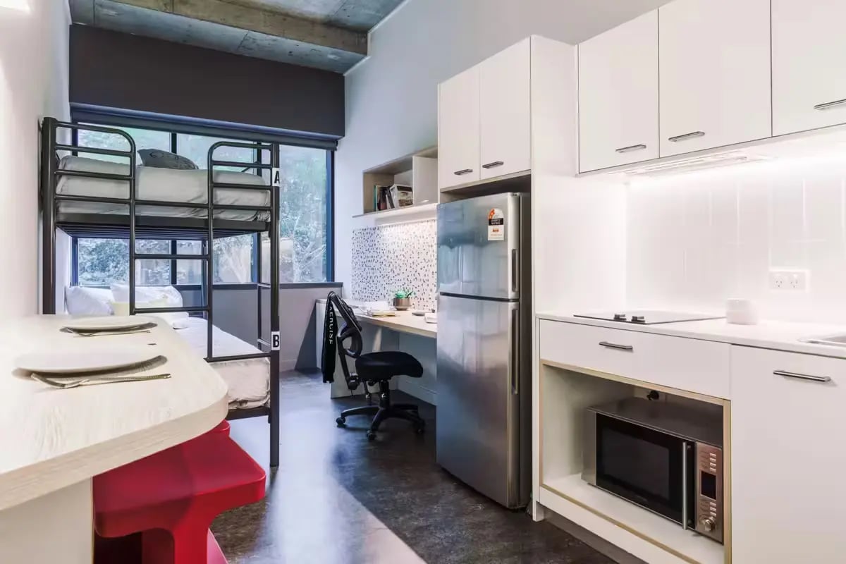 Bunk beds desk fridge kitchen microwave living room at Student One Adelaide Street in Brisbane Student Accommodation
