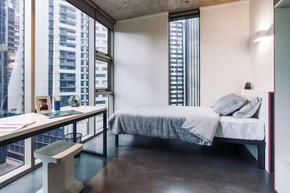 Bed desk with framed photo and stool bedroom at Student One Wharf Street in Brisbane Student Accommodation