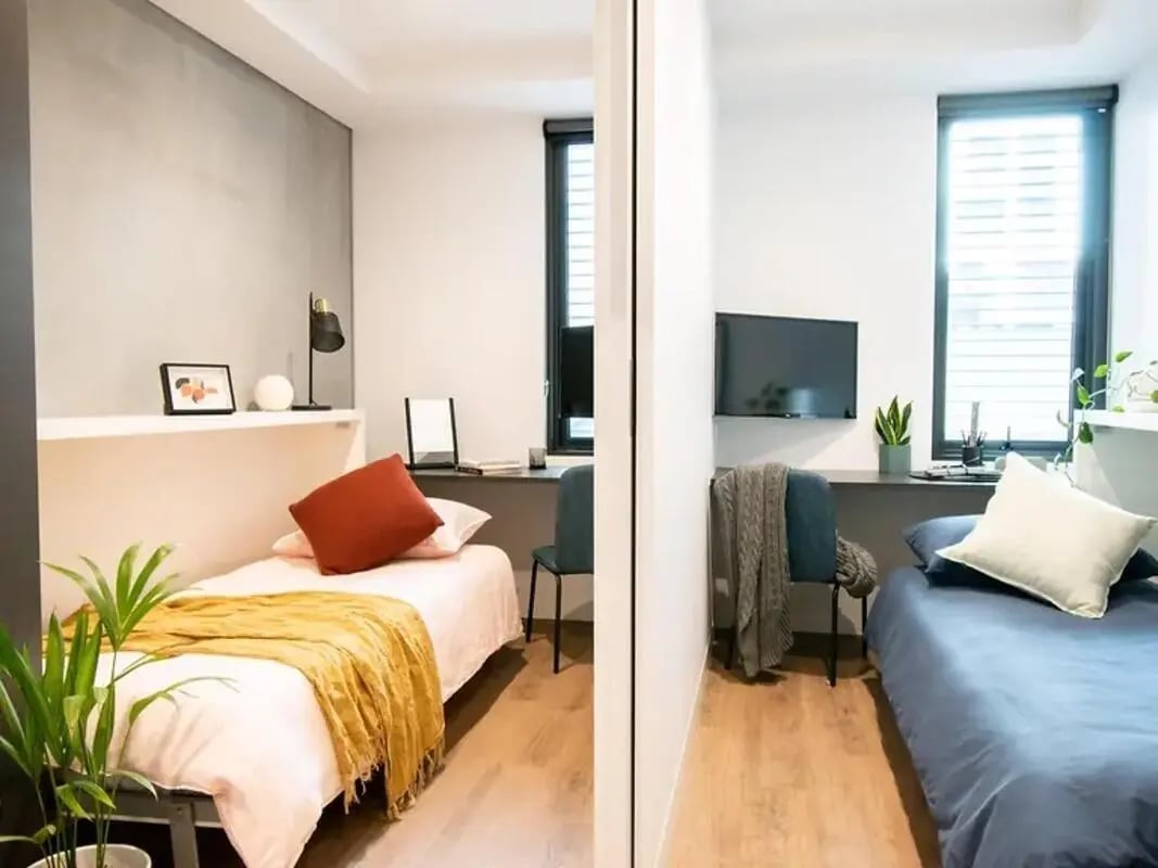 Two beds desk lamp framed art bedroom at Yugo University Square Melbourne in Melbourne Student Accommodation