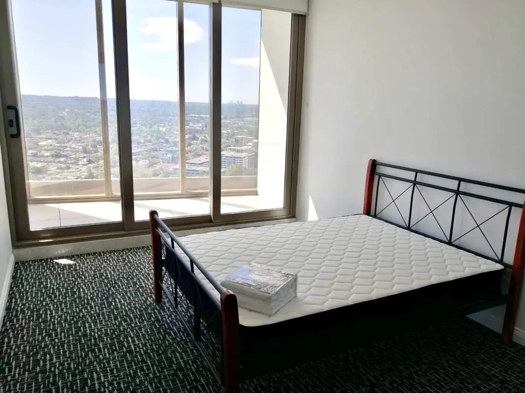 Bed with mattress and window view Bedroom at Belong Parramatta in Sydney Student Accommodation
