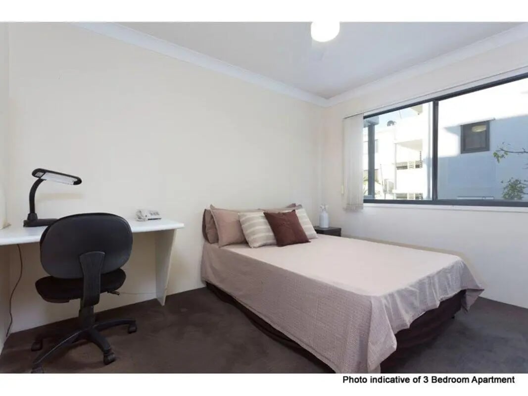 Desk chair lamp phone bed with pillows bedroom at Altitude Taringa in Brisbane Student Accommodation