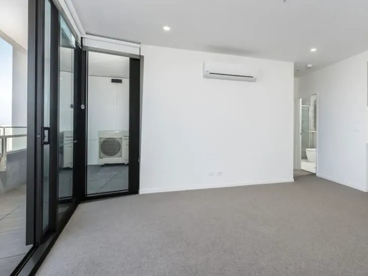 Empty room with AC and bathroom entrance living room at BELONG Newcastle NSW in Newcastle Student Accommodation