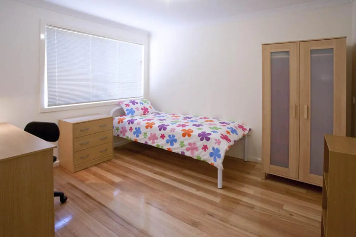 Bed dresser wardrobe desk bedroom at Sunset House in Melbourne Student Accommodation