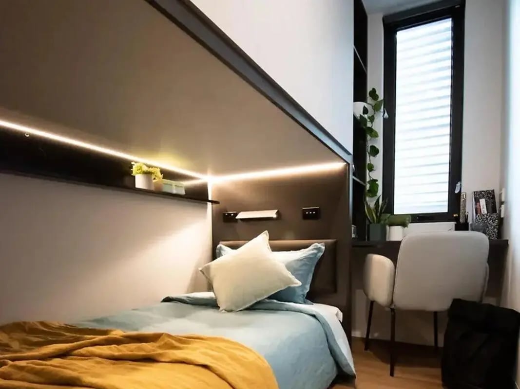 Bed desk chair plants window bedroom study area at Yugo University Square Melbourne in Melbourne Student Accommodation