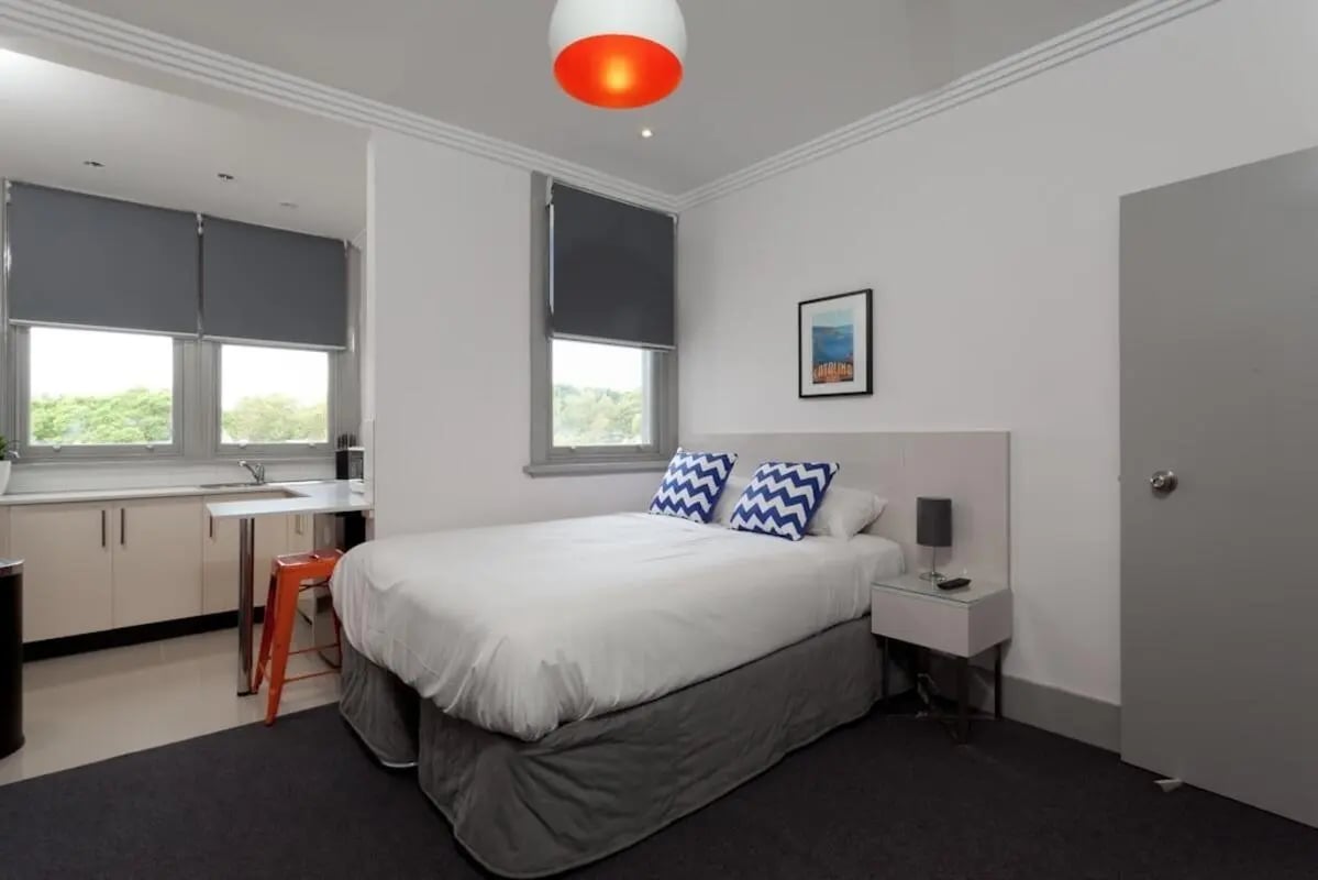 Bed kitchen area nightstand painting bedroom at ume Darlinghurst in Sydney Student Accommodation