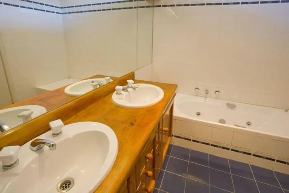 Double sinks wooden vanity bathtub bathroom at Greenwood House in Melbourne Student Accommodation