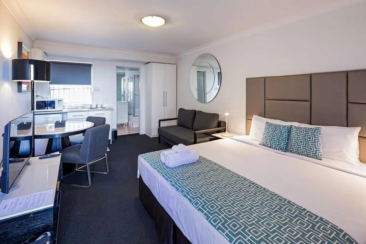 Bed kitchen sofa and desk student accommodation bedroom at ume Redfern Village in Sydney Student Accommodation
