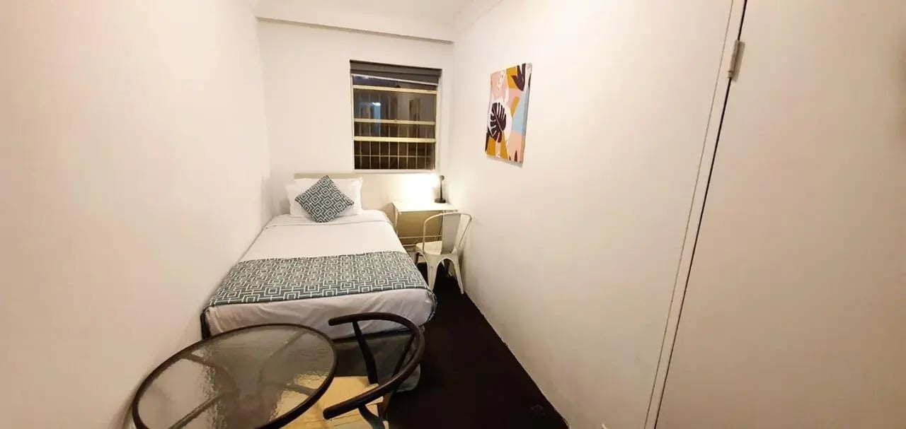 Single bed desk chair and table bedroom at ume Redfern Village in Sydney Student Accommodation