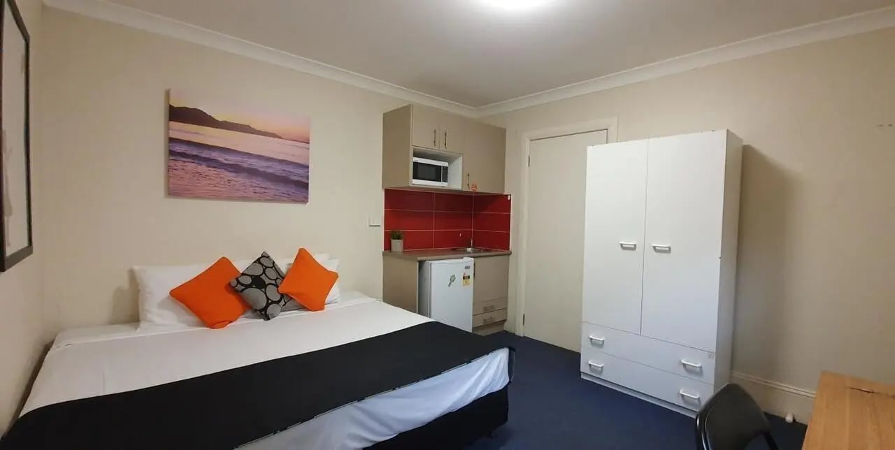 Bed kitchenette wardrobe and desk studio apartment at ume Redfern in Sydney Student Accommodation