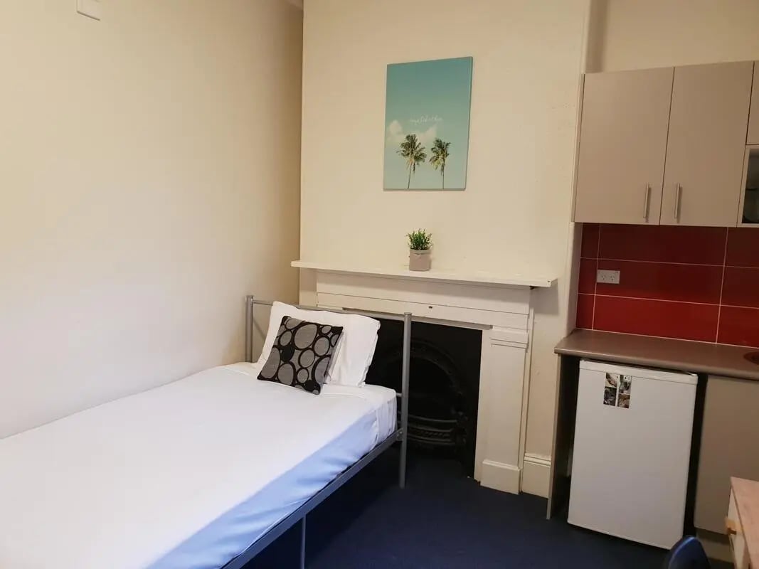 Single bed and small kitchen area bedroom at ume Redfern in Sydney Student Accommodation