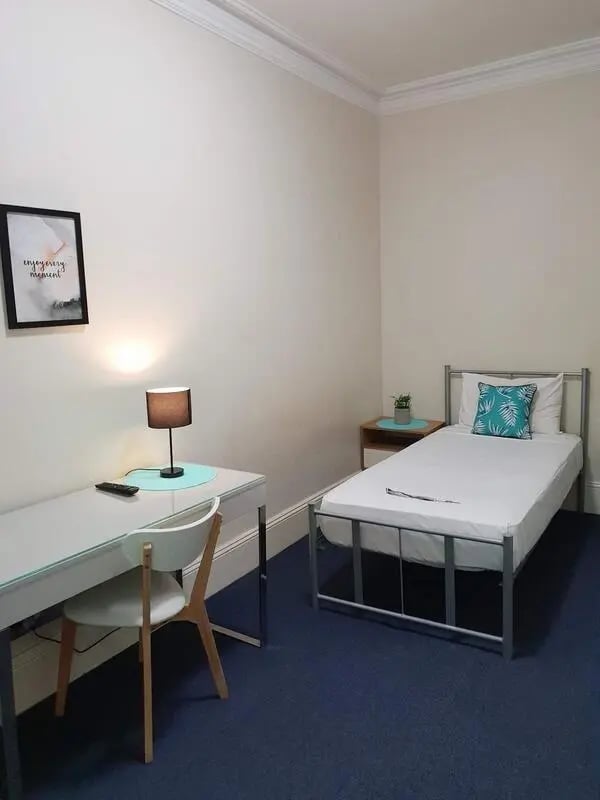 Bed desk chair artwork and plant bedroom at ume Redfern in Sydney Student Accommodation