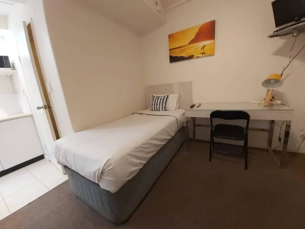 Bed desk chair with painting Bedroom at ume 152 Darlinghurst Village in Sydney Student Accommodation