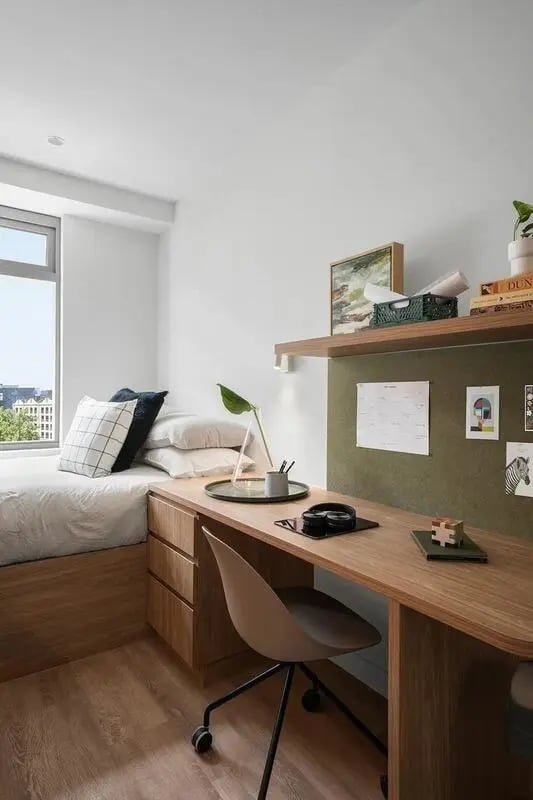 Bed desk chair and art on wall bedroom at Campus House in Melbourne Student Accommodation