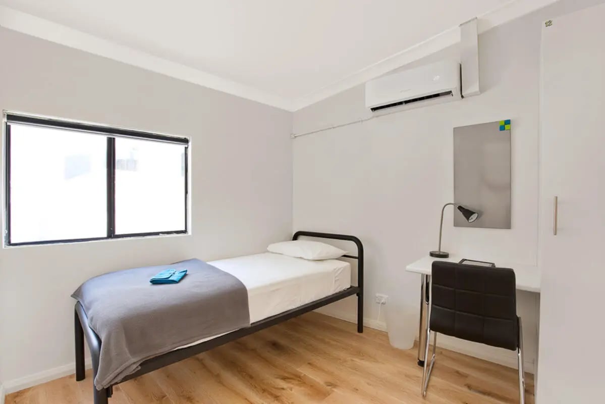 Bed desk chair and air conditioner bedroom at Link2 Central in Sydney Student Accommodation