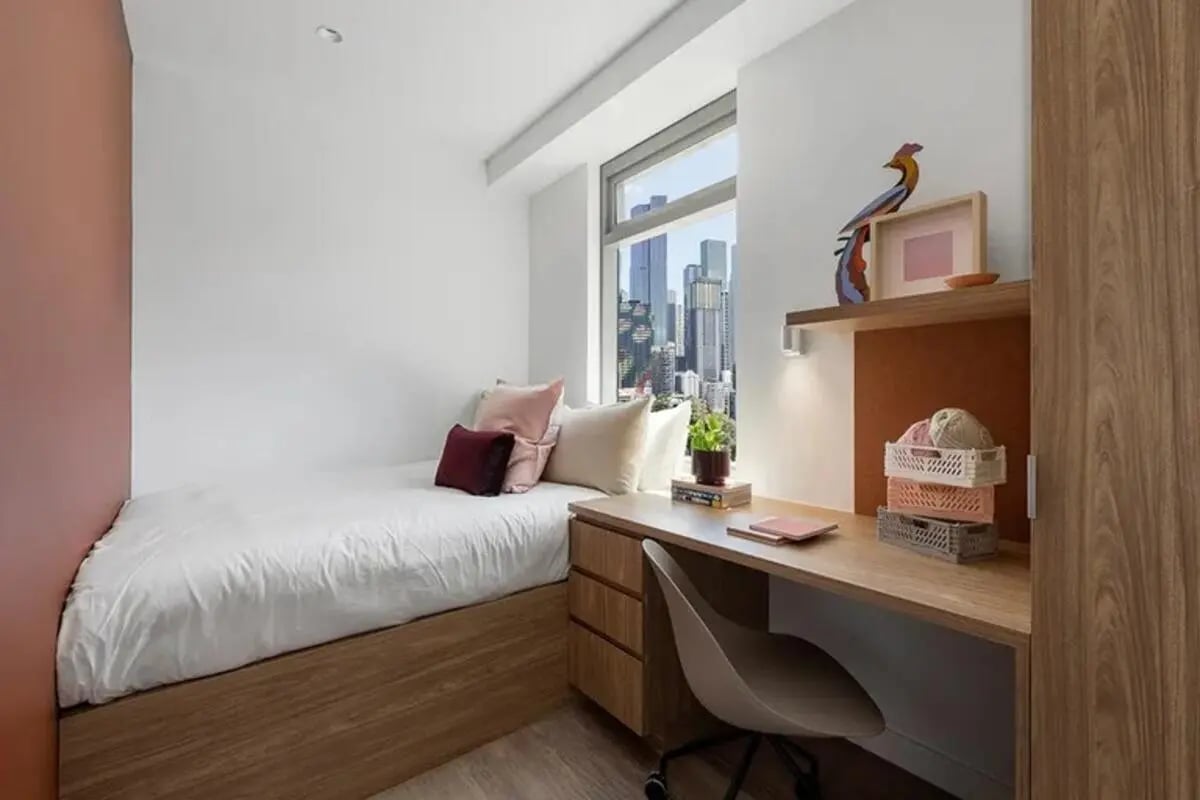 Bed desk pillows and baskets bedroom study area at Campus House in Melbourne Student Accommodation