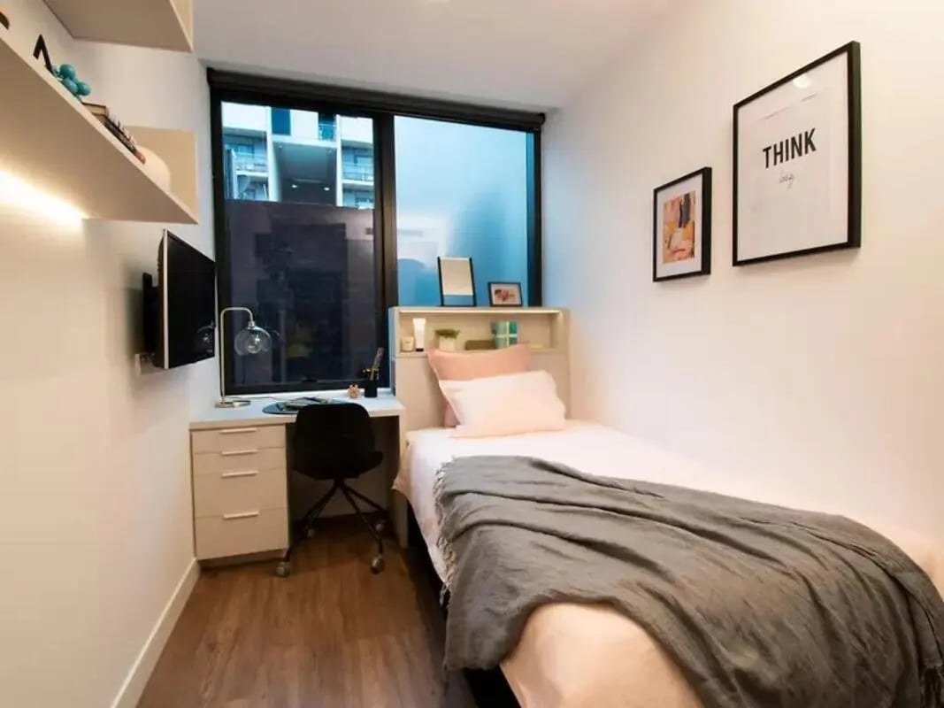 Desk bed framed art and shelves bedroom at Yugo Berkeley Street in Melbourne Student Accommodation