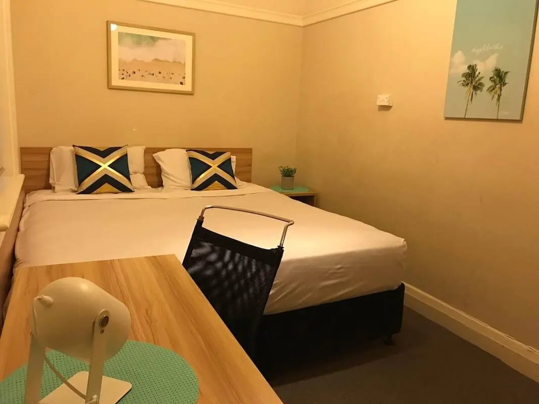 Bed desk chair and pillows bedroom at ume Potts Point in Sydney Student Accommodation