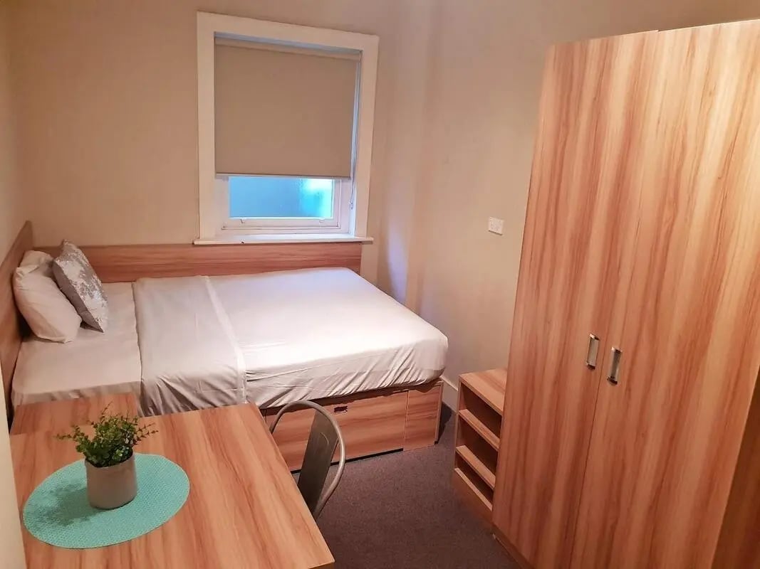 Bed wardrobe desk plant bedroom at ume Potts Point in Sydney Student Accommodation