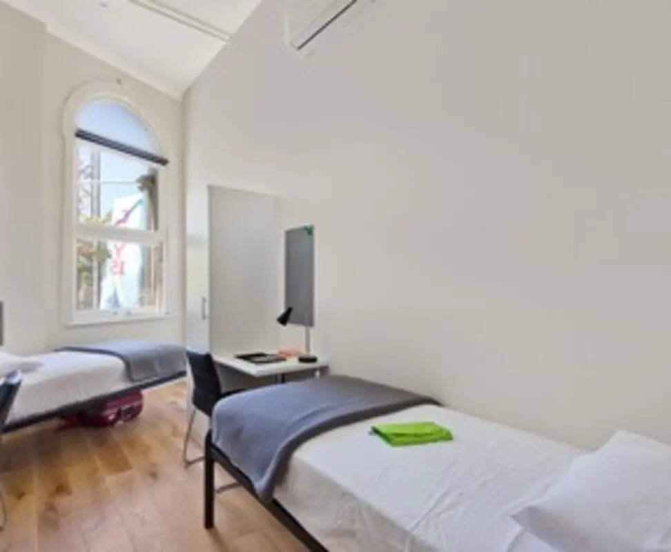 Two beds desk chair and window Bedroom at Link2 Broadway in Sydney Student Accommodation