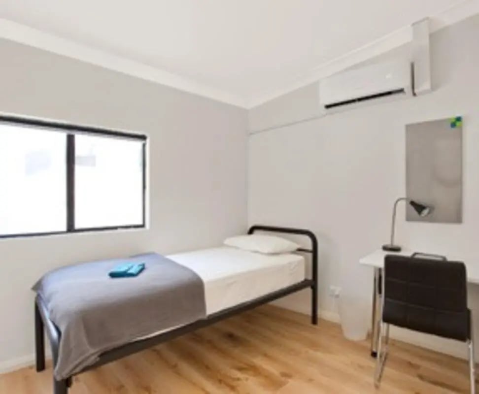 Single bed desk chair and air conditioner bedroom at Link2 Broadway in Sydney Student Accommodation