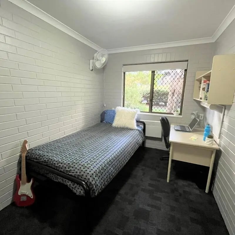 Bed desk fan guitar bedside with window bedroom at ECU Villlage Mount Lawley in Perth Student Accommodation