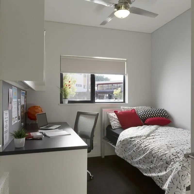 Desk laptop chair bed with pillows bedroom at ECU Villlage Mount Lawley in Perth Student Accommodation