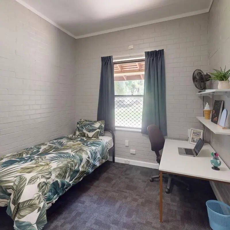 Bed desk fan and laptop student room at Murdoch University Village in Perth Student Accommodation