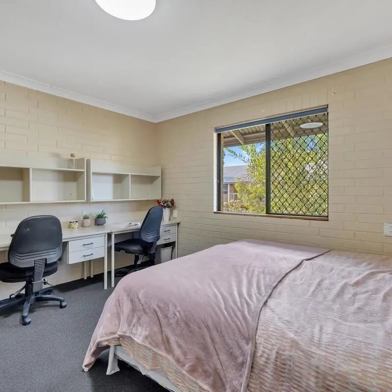 Two desks, two chairs, a bed, shelving Bedroom at Murdoch University Village in Perth Student Accommodation