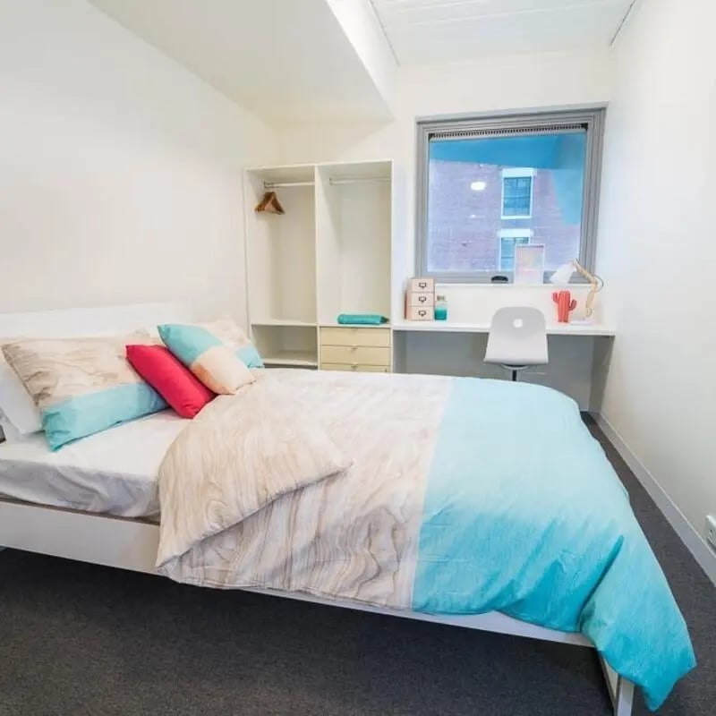 Bed closet desk chair and window bedroom at Student Village - University of Melbourne Campus in Melbourne Student Accommodation