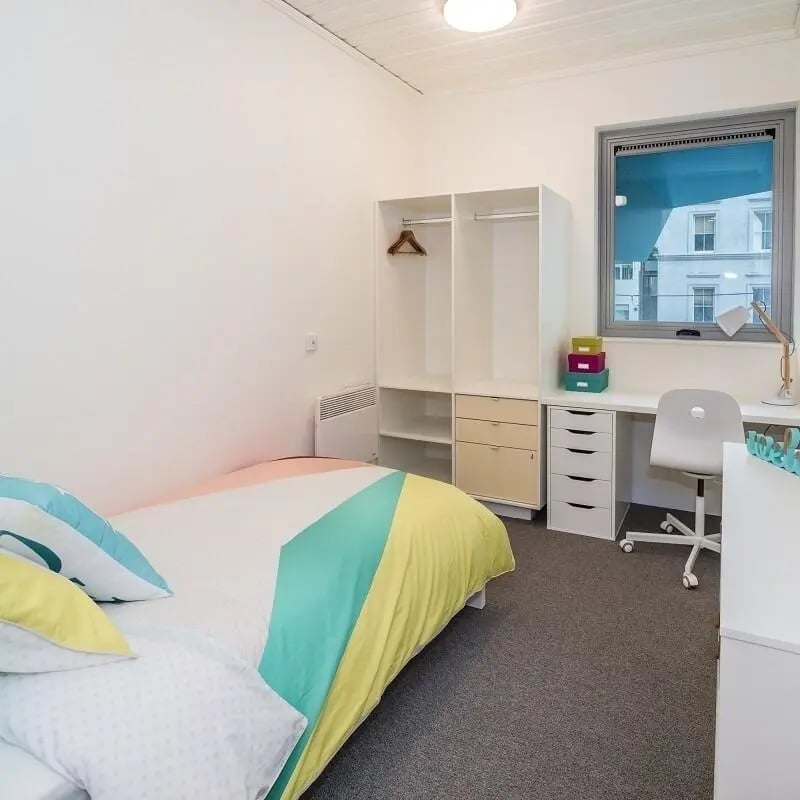 Bed desk wardrobe with colorful bedding bedroom at Student Village - University of Melbourne Campus in Melbourne Student Accommodation