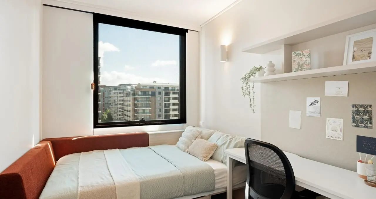 Bed desk and window with city view bedroom at Iglu Mascot in Sydney Student Accommodation