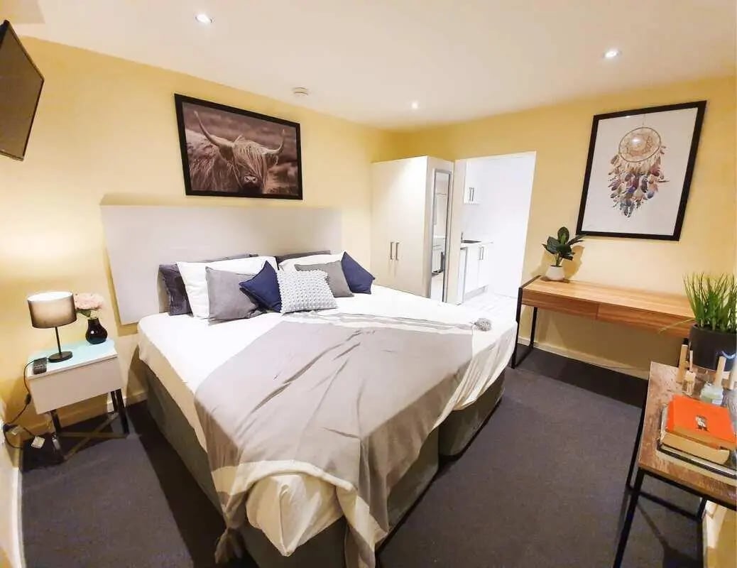 Bed with pillows bedside table and desk bedroom at ume 142 Darlinghurst Village in Sydney Student Accommodation