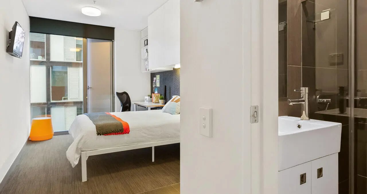 Bed desk and bathroom sink bedroom at Iglu Central Park in Sydney Student Accommodation