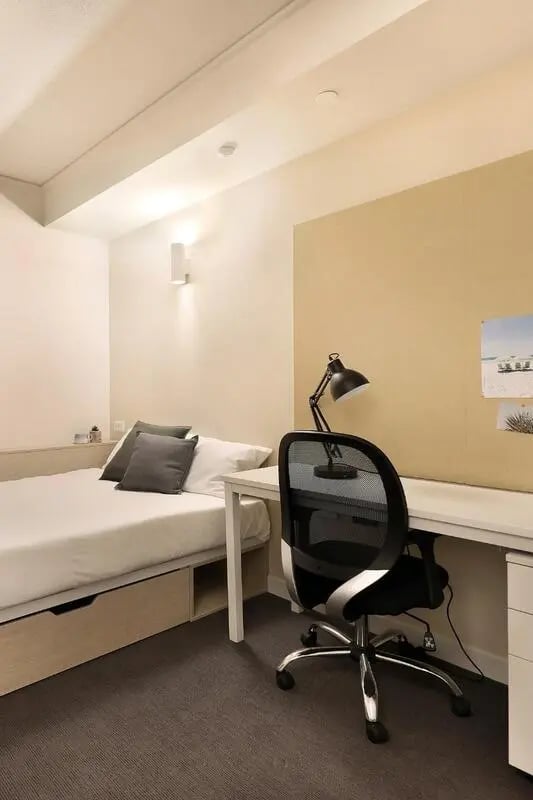 Bed desk chair and lamp bedroom study area at Iglu Flagstaff Gardens in Melbourne Student Accommodation