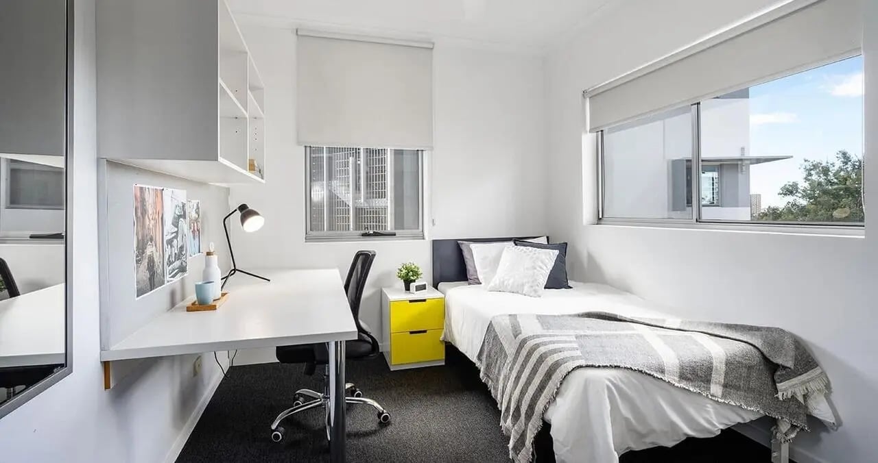 Desk bed lamp yellow drawers bedroom at Iglu Kelvin Grove in Brisbane Student Accommodation