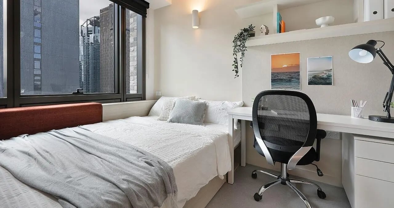 Bed desk chair and window Bedroom at Iglu Melbourne Central in Melbourne Student Accommodation