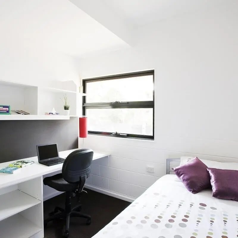 Desk laptop chair red lamp bedding Bedroom at Western Sydney University Village Parramatta Campus in Sydney Student Accommodation