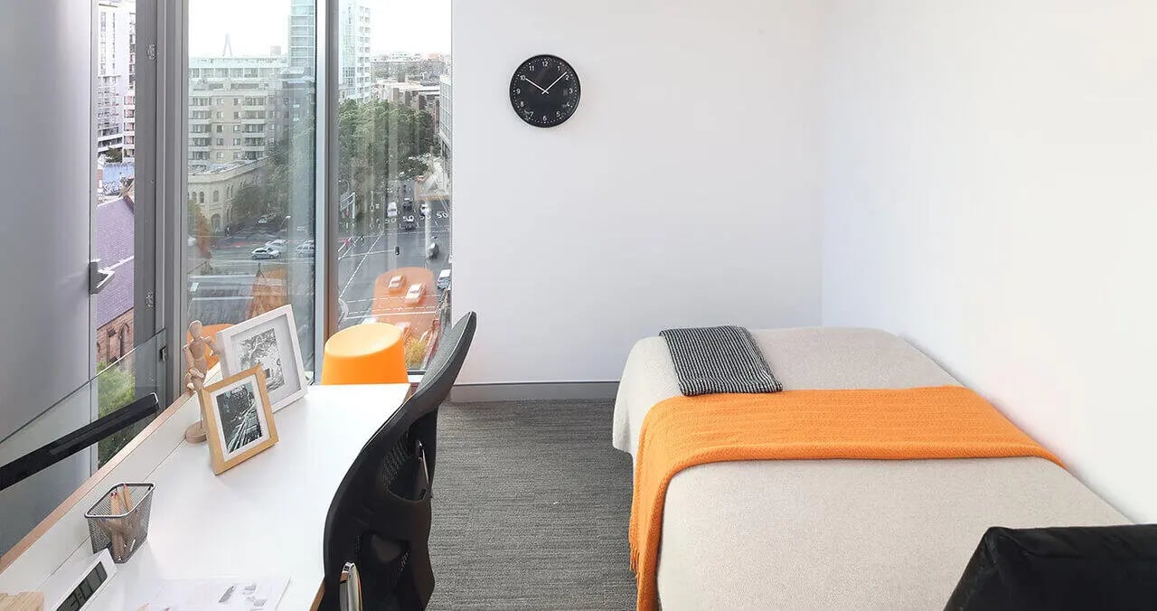Bed desk and clock bedroom at Iglu Central Park in Sydney Student Accommodation