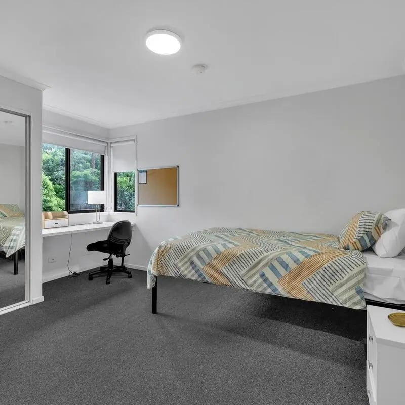 Bed desk chair mirror and bulletin board bedroom at Student Village North Ryde in Sydney Student Accommodation