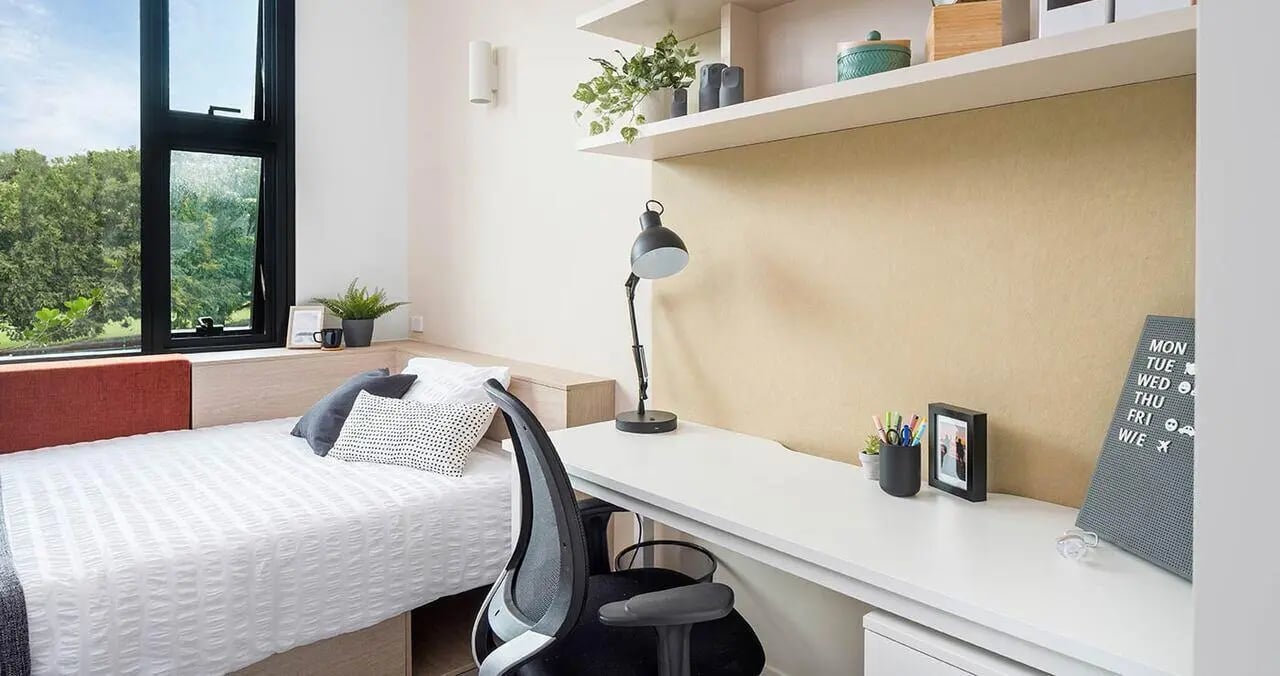 Bed desk chair with lamp and calendar bedroom at Iglu Summer Hill in Sydney Student Accommodation