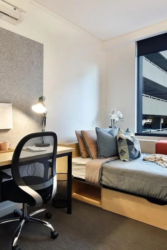 Desk chair lamp bed with pillows bedroom at Iglu South Yarra in Melbourne Student Accommodation