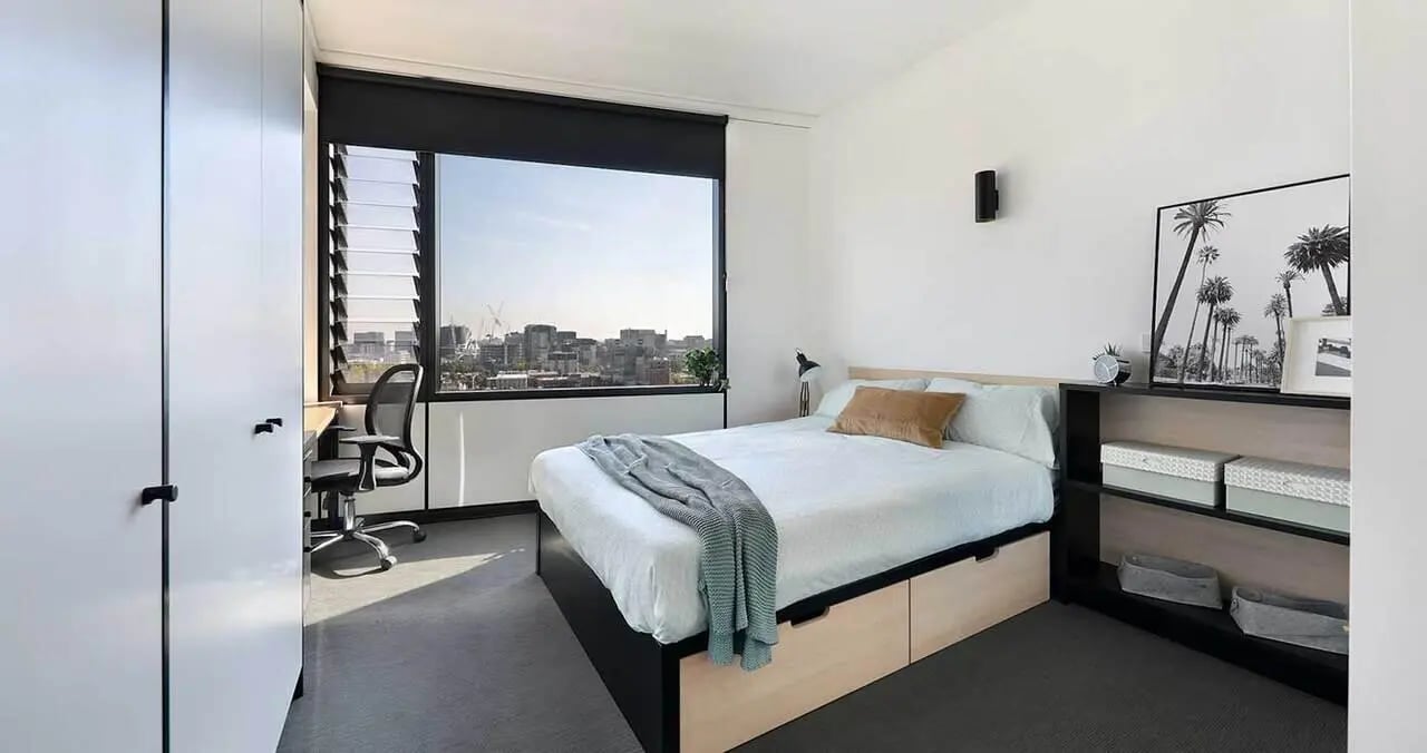 Bed desk chair shelving with boxes bedroom at Iglu Melbourne City in Melbourne Student Accommodation